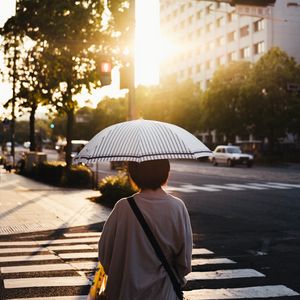 Preview wallpaper street, man, umbrella, sun, city