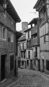 Preview wallpaper street, paving stones, buildings, houses, windows, black and white