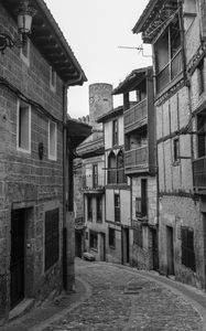 Preview wallpaper street, paving stones, buildings, houses, windows, black and white