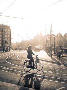 Preview wallpaper street, road, bicycle, people, light, sun, black white