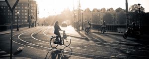 Preview wallpaper street, road, bicycle, people, light, sun, black white