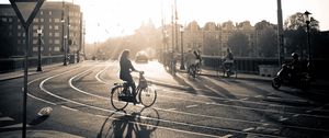 Preview wallpaper street, road, bicycle, people, light, sun, black white