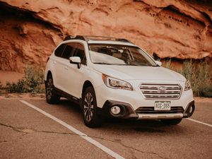 Preview wallpaper subaru, car, side view, white, rocks