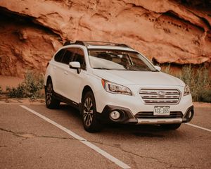 Preview wallpaper subaru, car, side view, white, rocks