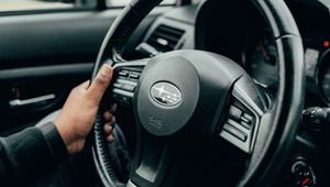 Preview wallpaper subaru, car, steering wheel, hands, black