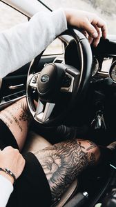 Preview wallpaper subaru, man, tattoo, wheel, interior, car