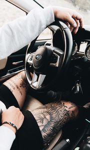 Preview wallpaper subaru, man, tattoo, wheel, interior, car