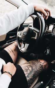 Preview wallpaper subaru, man, tattoo, wheel, interior, car