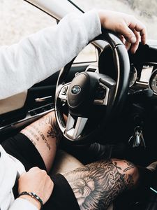 Preview wallpaper subaru, man, tattoo, wheel, interior, car