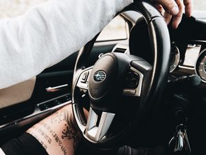 Preview wallpaper subaru, man, tattoo, wheel, interior, car