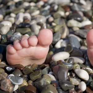Preview wallpaper summer, sea, legs, pebble, beach, funny, situation