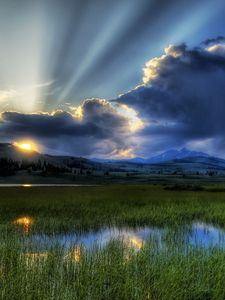 Preview wallpaper sun, beams, clouds, mountains, bog, canes, sky