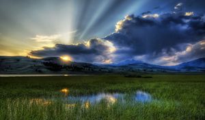 Preview wallpaper sun, beams, clouds, mountains, bog, canes, sky