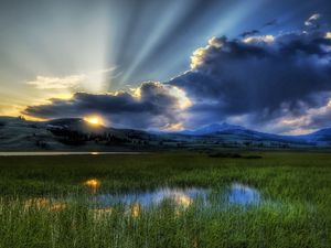 Preview wallpaper sun, beams, clouds, mountains, bog, canes, sky