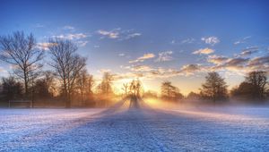 Preview wallpaper sun, beams, field, football, gate, hoarfrost, frosts