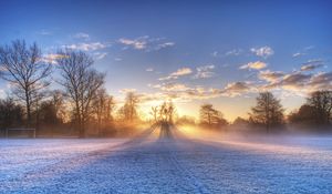 Preview wallpaper sun, beams, field, football, gate, hoarfrost, frosts