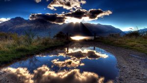 Preview wallpaper sun, clouds, lake, reflection, light, shadows, mountains, sky
