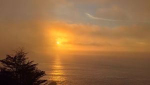 Preview wallpaper sun, clouds, sea, fog, twilight, dark