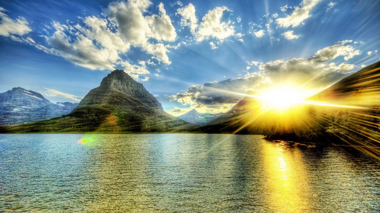 Wallpaper sun, light, beams, lake, evening, decline, ripples, mountains, peaks
