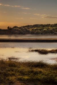 Preview wallpaper sun, light, lake, fisherman, coast, grass, faded, reflection