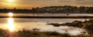 Preview wallpaper sun, light, lake, fisherman, coast, grass, faded, reflection