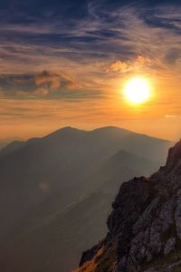 Preview wallpaper sun, light, rock, person, clouds, sky, height, climber, conquest