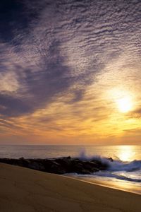 Preview wallpaper sun, sky, clouds, sea, waves, stones, breakwater