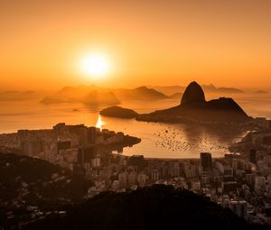 Preview wallpaper sun, sunset, city, shore