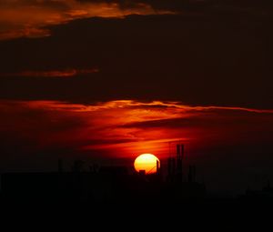 Preview wallpaper sun, sunset, clouds, building, dark