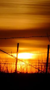 Preview wallpaper sun, sunset, silhouettes, grass, clouds, sky, dark