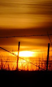 Preview wallpaper sun, sunset, silhouettes, grass, clouds, sky, dark