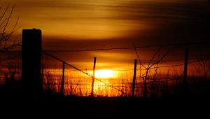 Preview wallpaper sun, sunset, silhouettes, grass, clouds, sky, dark