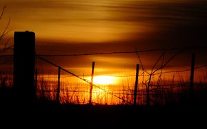 Preview wallpaper sun, sunset, silhouettes, grass, clouds, sky, dark