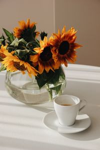 Preview wallpaper sunflowers, bouquet, cup, vase, table
