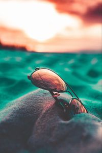 Preview wallpaper sunglasses, sand, close-up, blurred