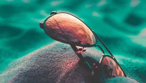 Preview wallpaper sunglasses, sand, close-up, blurred