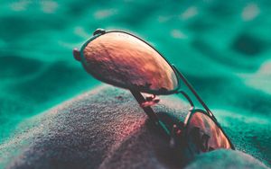 Preview wallpaper sunglasses, sand, close-up, blurred