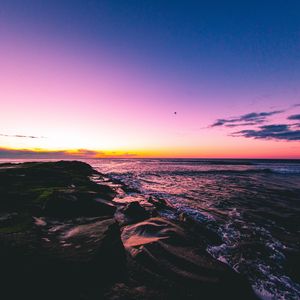 Preview wallpaper sunset, beach, sea, stones