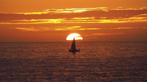 Preview wallpaper sunset, boat, sea, sun, waves, dusk
