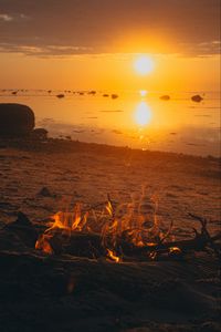 Preview wallpaper sunset, bonfire, coast, sand