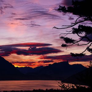 Preview wallpaper sunset, branches, sky, clouds, mountains