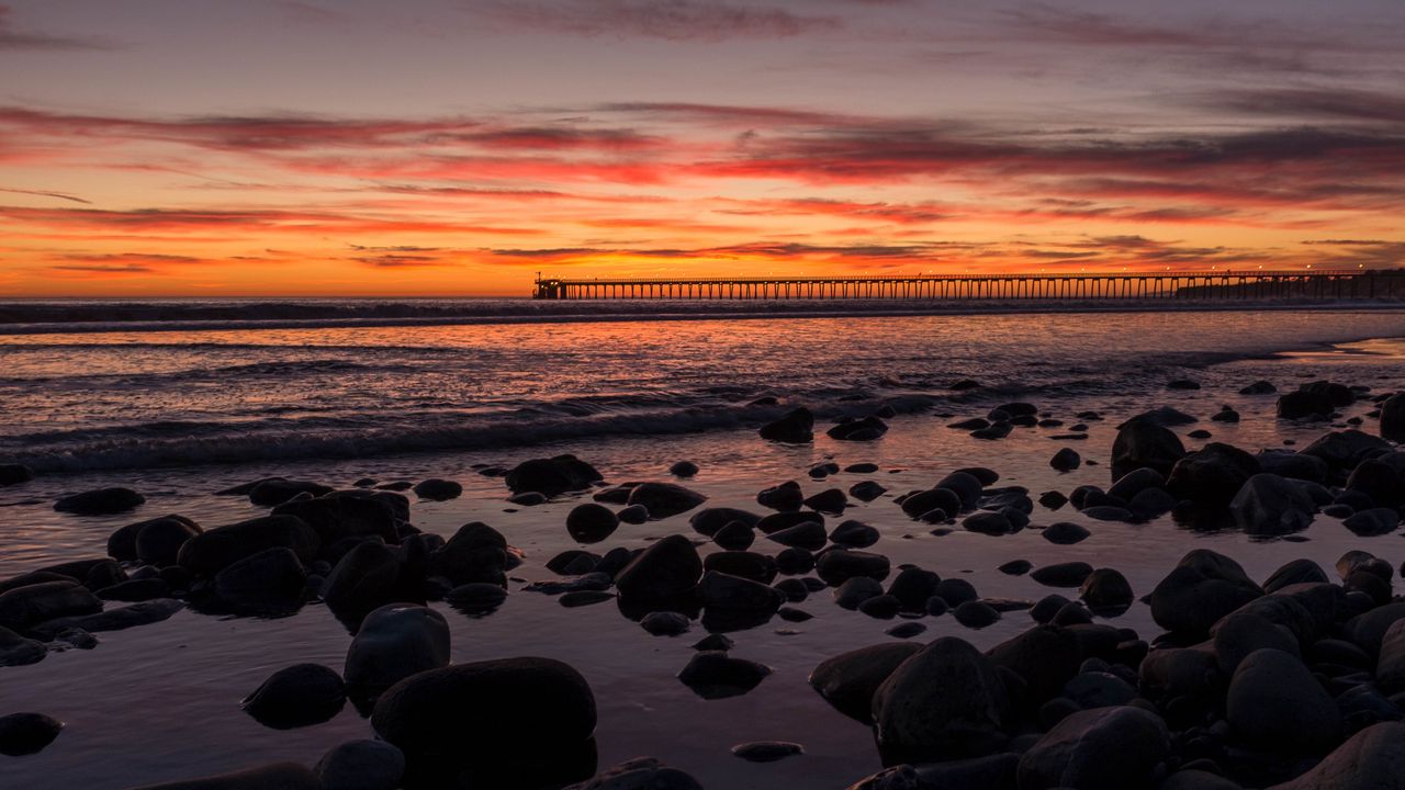 Wallpaper sunset, bridge, sea, stones, horizon