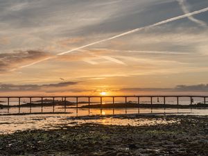 Preview wallpaper sunset, bridge, sea, horizon, sky