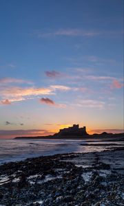 Preview wallpaper sunset, castle, coast, waves, horizon