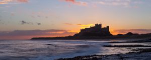 Preview wallpaper sunset, castle, coast, waves, horizon