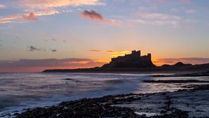 Preview wallpaper sunset, castle, coast, waves, horizon