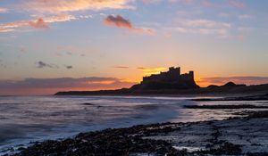 Preview wallpaper sunset, castle, coast, waves, horizon