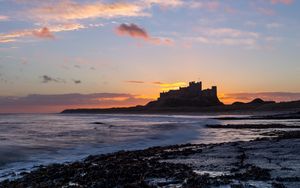 Preview wallpaper sunset, castle, coast, waves, horizon