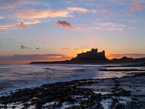 Preview wallpaper sunset, castle, coast, waves, horizon