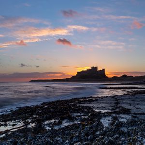 Preview wallpaper sunset, castle, coast, waves, horizon